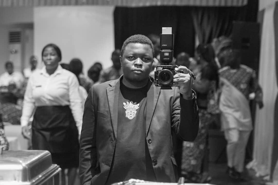 Chap Nic holding his camera and flash