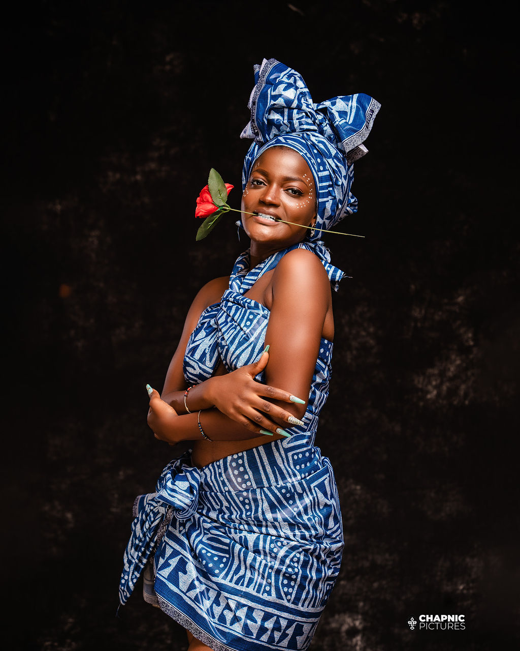A studio portrait in a blue patterned dress and matching headwrap - Chap Nic Pictures